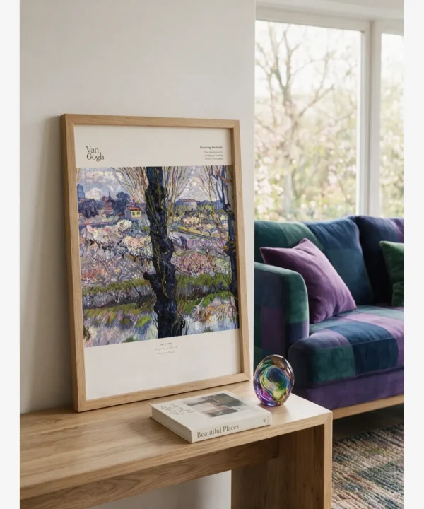 Vincent van Gogh's "Flowering Orchards, Arles" poster featuring blooming fruit trees, dark tree trunks, and a distant view of the city
